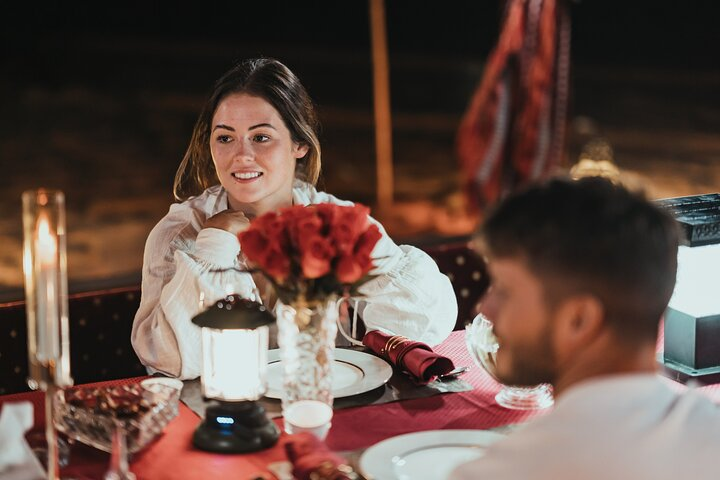 Enjoy a romantic dinner under a starlit sky surrounded by the serene desert savoring delicious BBQ and local delicacies while creating unforgettable memories together.